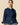 Rowing Blazers Women’s Fitted Lace Collar Button Down Shirt Navy, a tailored cotton blouse with thin green vertical stripes, featuring an embroidered double-collared design and a small rectangular patch near the hem.