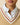 Close-up of a Women’s Cotton Blend Cable Dress Camel in tan with white and red striped trim, layered over a white collared shirt.