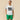 A person wears a cream-colored Rowing Blazers Open Weave Sweater Jersey with the number 99 in black on the chest, paired with green shorts.