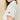White shirt with a red club emblem on a beige background