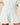 Women’s Button Down Pleated Shirt Dress White in 100% cotton, featuring a long-sleeved button-down design with a wide, wrapped waistband and a pleated skirt.