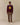 A model wears a burgundy Chenille Patch Cotton Sweater featuring a large yellow chenille varsity patch letter R with the word BLAZERS vertically inside it, layered over a light blue collared shirt and brown pleated trousers.