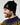 A person wearing a black Derry Bones Santa Beanie made of wool and cashmere, featuring a goldwork Derry Bones patch embroidered on the ribbed cuff.