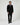 A man wears a Rowing Blazers Men’s Velvet Classic Tuxedo Pant Black, matching black velvet double-breasted tuxedo jacket, white shirt, and colorful patterned bow tie.