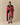 A person stands wrapped in a cozy Sheep Sherpa Throw Blanket Diana Red featuring a red and white sheep pattern.