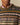 A person wears the Rowing Blazers Donegal Fair Isle Crew Sweater Green over a pink collared shirt, showing only the lower face and upper torso.