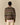 A person faces away, wearing the Rowing Blazers Donegal Fair Isle Crew Sweater Green over a pink collared shirt and light beige pants, set against a plain beige background.