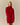 A woman wearing a red Korryn Turtleneck Mini Sweater Dress with a ribbed skirt.