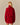 Back view of a person wearing a red Korryn Turtleneck Mini Sweater Dress with a ribbed skirt.