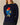 Navy blue Rowing Blazers x Paddington™ Penelope Paddington Cashmere Sweater in a fitted silhouette, featuring an intarsia knit of Paddington bear wearing a red hat and blue duffle coat while holding a jar labeled Marmalade.