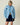 Warm & Wonderful Sheep Sherpa Jacket Blue featuring a light blue sherpa fleece zip-up pattern with small white sheep and one black sheep, worn over navy blue athletic shorts.