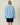 Back view of a person wearing a fuzzy blue Sheep Sherpa Jacket featuring a repeating white sheep pattern.
